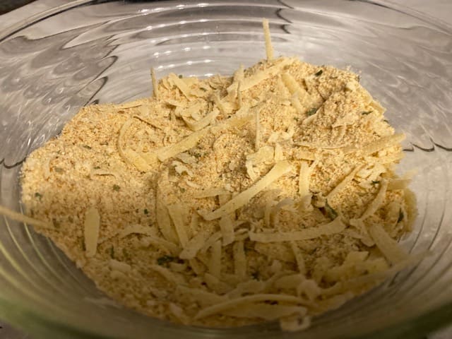 Bowl filled with bread crumbs, parmesan, oregano, chili powder, and garlic salt.