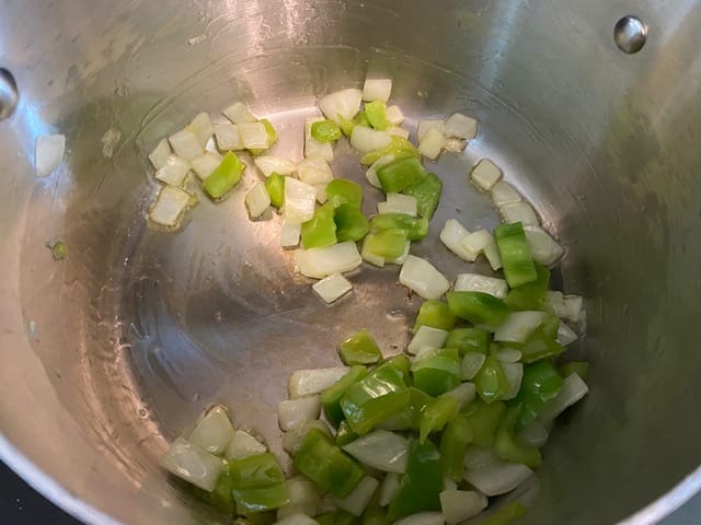 Onion and green pepper saluting in a pan.