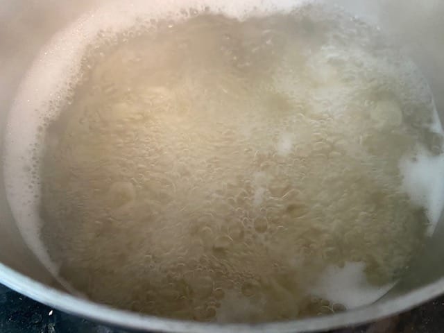 Water boiling with macaroni noodles